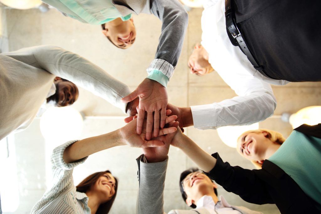 United team celebrates with hands in the middle.